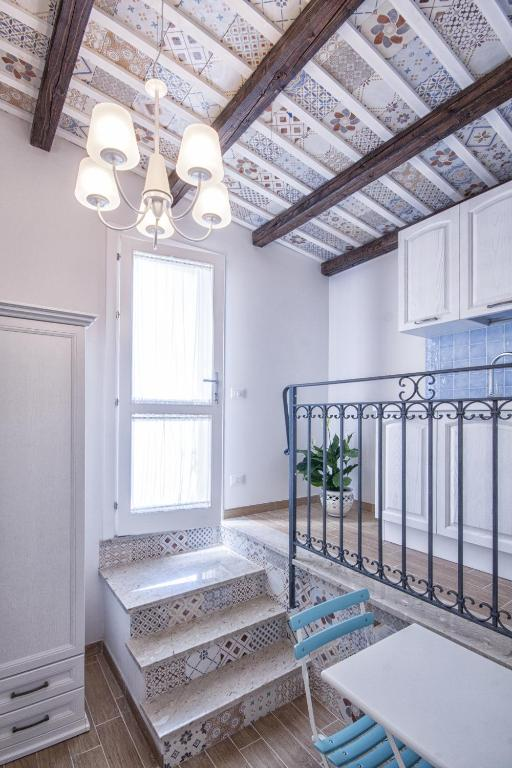 Interior with Sicilian tile details and exposed wooden beams
